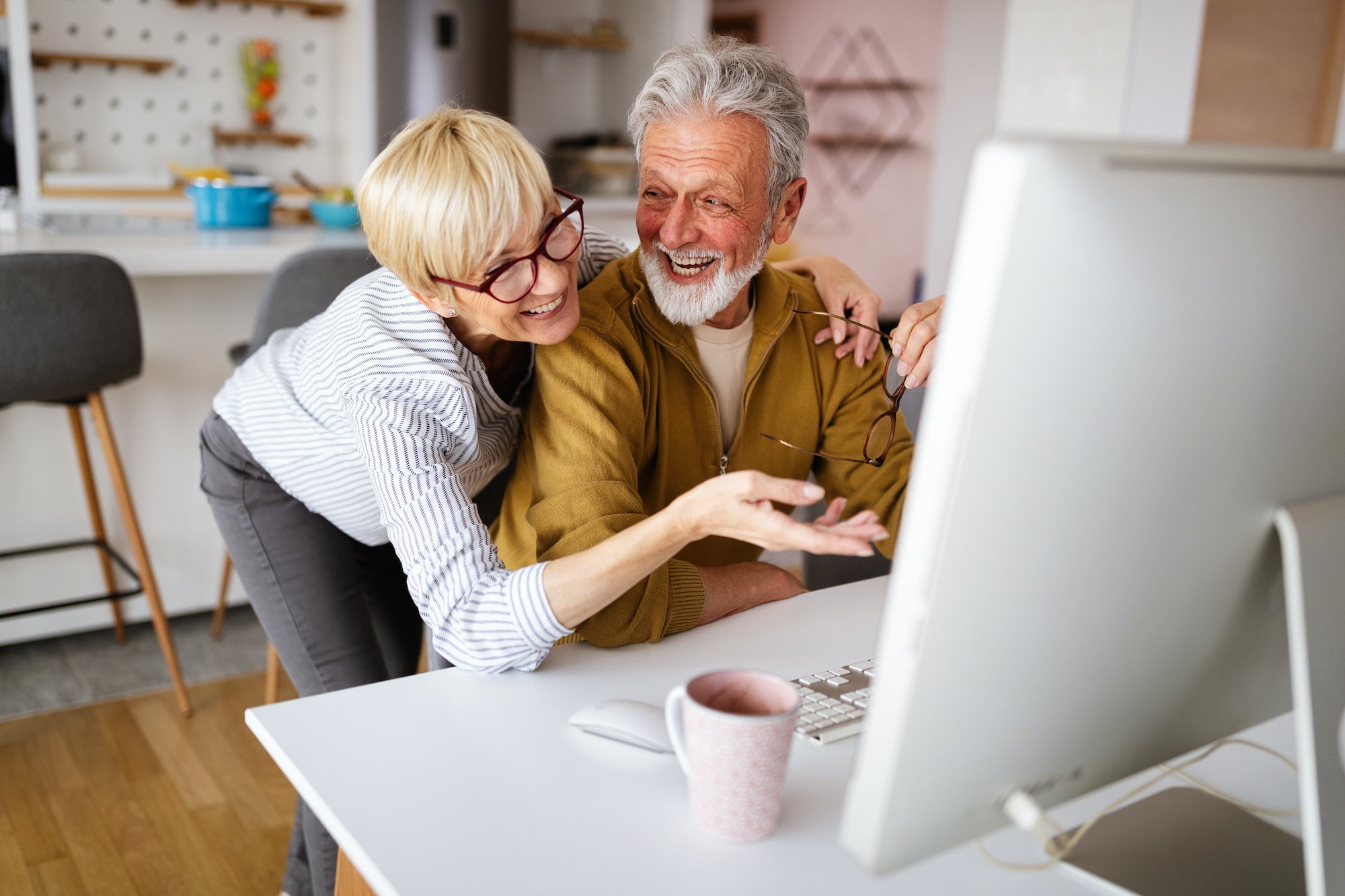 Senior retired couple learn about computer and online support
